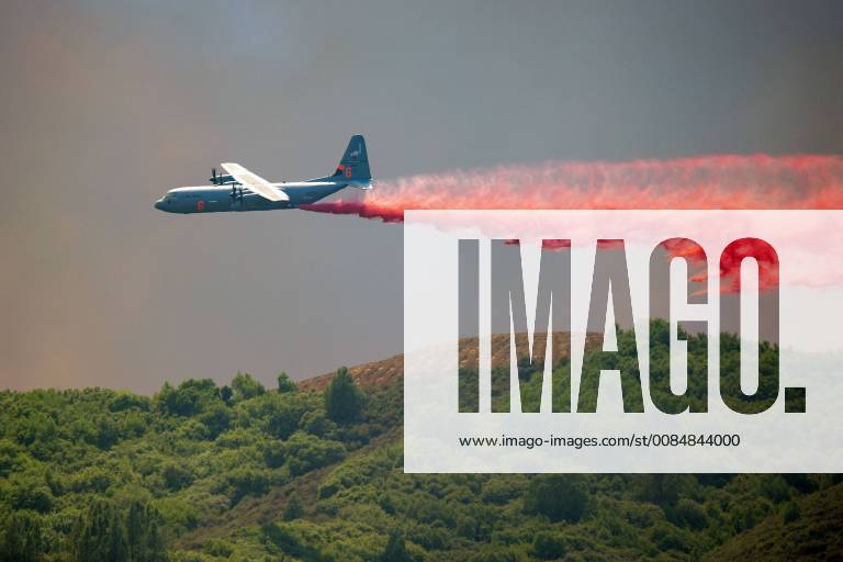 California, U.S. - A C-130 Air Tanker drops fire retardant on a ridge West of Scotts Valley Road near Lakeport, California, to help hold a dozer line attempting to slow the spread of the River Fire burning in Lake and Mendocino Counties. The River Fire is one of two fires making up the Mendocino Complex Fire burning around the west end of Clear Lake. Both fires, the Ranch to the north and the River to the south, are still large and growing. Together they now total 90,912 acres and are still only 24% contained. Lakeport U.S. - ZUMAmk2_ 20180801_zap_mk2_011