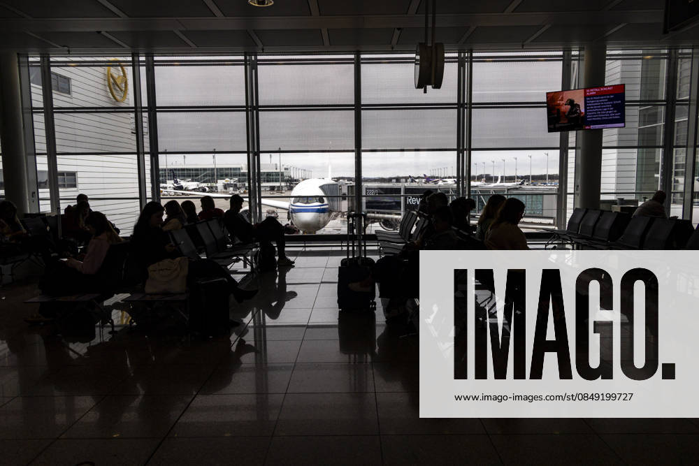 Silhouettes Of Passengers Waiting At An Airport Terminal Silhouettes of international passengers walking with luggage and bags while others are sitting and waiting at a modern airport terminal next to the passenger boarding gates with an Airbus A350 aircraft of Air China visible behind them at the apron of Munich Airport MUC, or Flughafen München, named after the former Bavarian minister-president Franz Josef Strauss, the second busiest airport in Germany hub for the German airline Lufthansa. Munich, Germany on February 22, 2026 Munich Germany