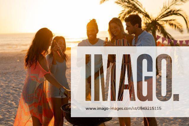 Mixed race friends doing barbecue on beach A multi-ethnic group of friends enjoying their time together on a beach during sunset, drinking beer and drinks, making a barbecue, model released, , property released, Cape Town, South Africa, 25.02.2020, 1345481.jpg, people,standing,drinking,beer,drink,bottle,making,barbecue,bbq,grilling,vegetables,real people,happy,smiling,friends,friendship,together,gen z,generation z,holidays,vacation,beach,sea,ocean,tropical,coast,summer,beachwear,seaside,enjoying,sun,leisure,freedom,free time,time off,relaxing,fun,escapism,weekend Young Adult,Woman,Female,Caucasian,Man,Male,Mixed-Race Outdoors,Day,Full frame background