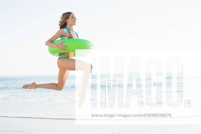 Beautiful young woman holding a rubber ring Beautiful young woman holding a rubber ring jumping on the beach, model released, Cape Town, South Africa, 11.07.2013, 222006.jpg, fit, toned, healthy, fitness, health, physical, shape, sporty, athletic, slim, slender, body, attractive, pretty, beautiful, wellness, body care, striped, bikini, beachwear, swimwear, fair hair, blonde, long hair, curly hair, natural, active, leisure, lifestyle, coastline, shore, summertime, holidays, ocean, sea, beach, waves, water, sunny, bright, vacation, sand, jumping, leaping, jump, happy, smiling, cheerful, rubber ring, green, holding, wearing, joy, freedom, escape, escapism Young Adult, Woman, Female, Caucasian, 18-19 Years, Young Women, Caucasian Ethnicity Ou