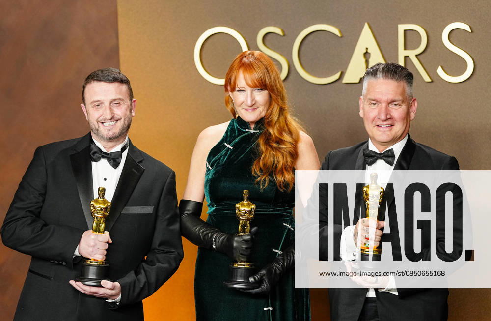 Mike Hill, Cliona Furey, and Jordan Samuel celebrate in the press photo room after winning the Makeup and Hairstyling Oscar for Frankenstein during the 98th annual Academy Awards in the Hollywood section of Los Angeles on Sunday, March 15, 2026. Conan O Brien is hosting the Oscars for the second consecutive year. LAP20260315336 BONNIExCASH