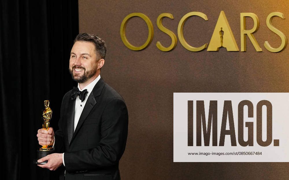 Andy Jurgensen celebrates in the press photo room after winning the Best Film Editing Oscar for One Battle After Another during the 98th annual Academy Awards in the Hollywood section of Los Angeles on Sunday, March 15, 2026. LAP20260315385 BONNIExCASH