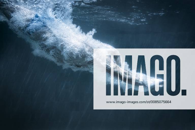 An image of a diving man in a black pool