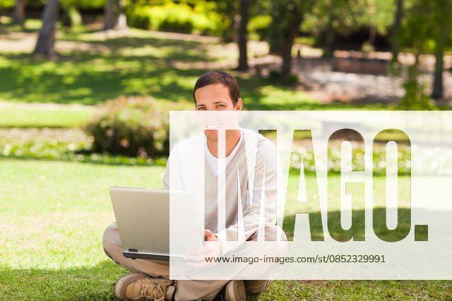 Man working on his laptop in the park Man working on his laptop in the park during the summer, model released, Cape Town, South Africa, 16.11.2010, 59517.jpg, attractive, carefree, garden, green, greenery, handsome, happiness, happy, leisure, lifestyle, outdoor, outside, park, relax, relaxation, smile, summer, smiling, tree, sit, sitting, pose, posing, looking, technology, communication, laptop, notebook, internet, using, working 30s, Mid Adult, Man, Male, Caucasian, Caucasian Appearance, 30-34 Years, Mid Adult Men Outdoors