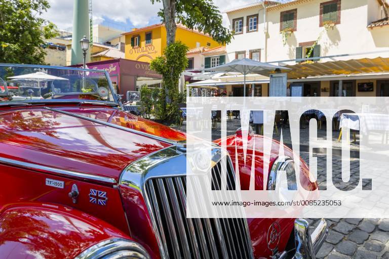 View of red vintage MG car in front of traditional Al Fresco restaurant in old town, Funchal, Madeira, Portugal, Europe
