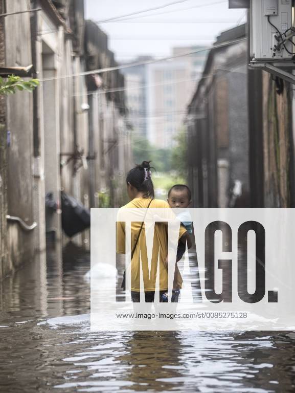 A woman carrying a child walks in a flooded road at Chendian Town after a heavy rainstorm on September 2, 2018 in Shantou, Guangdong Province of China. Heavy rainstorm hit Shantou, causing direct economic losses worth 2.35 billion yuan (344 million dollars) until Sunday.