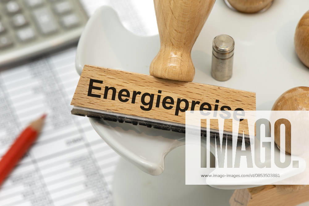 Energiekosten und Energiepreise Ein Holzstempel ist beschriftet mit dem Aufdruck Energiepreise als Symbolbild für steigende Kosten für Energie in Wirtschaft, Industrie und Handel - digital bearbeitet -