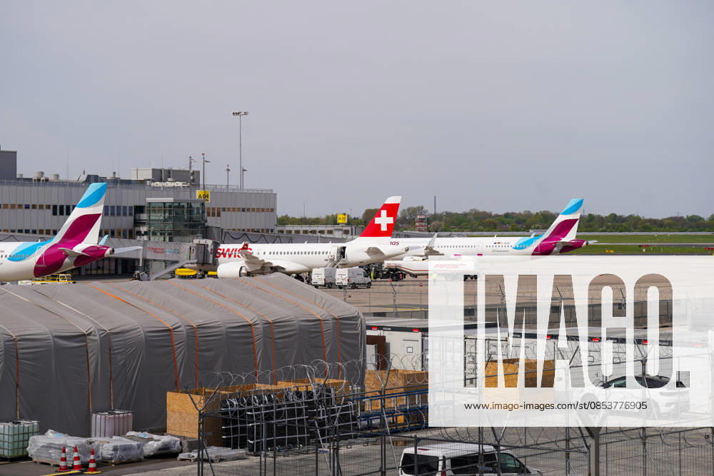 Düsseldorf, Nordrhein-Westfalen, Deutschland, Europa, Flughafen Düsseldorf, Airport, Vorfeld, Rollfeld, Infrastruktur, Luftfahrt, Passagierflugzeuge, Flugzeug, Airbus, SWISS, Lufthansa Group, Eurowings, Airline, Flugverkehr, Bodenabfertigung, Tankfahrzeug AFS, Betankung, Ground Handling, Ausrüstung, Equipment, Wartung, Logistik, Reiseverkehr, Mobilität, Terminalgebäude, Fluggastbrücke, Sicherheitszaun, Stacheldraht, Baustellenbereich, Container, Fahrzeuge, Wirtschaft, Transport, Totale