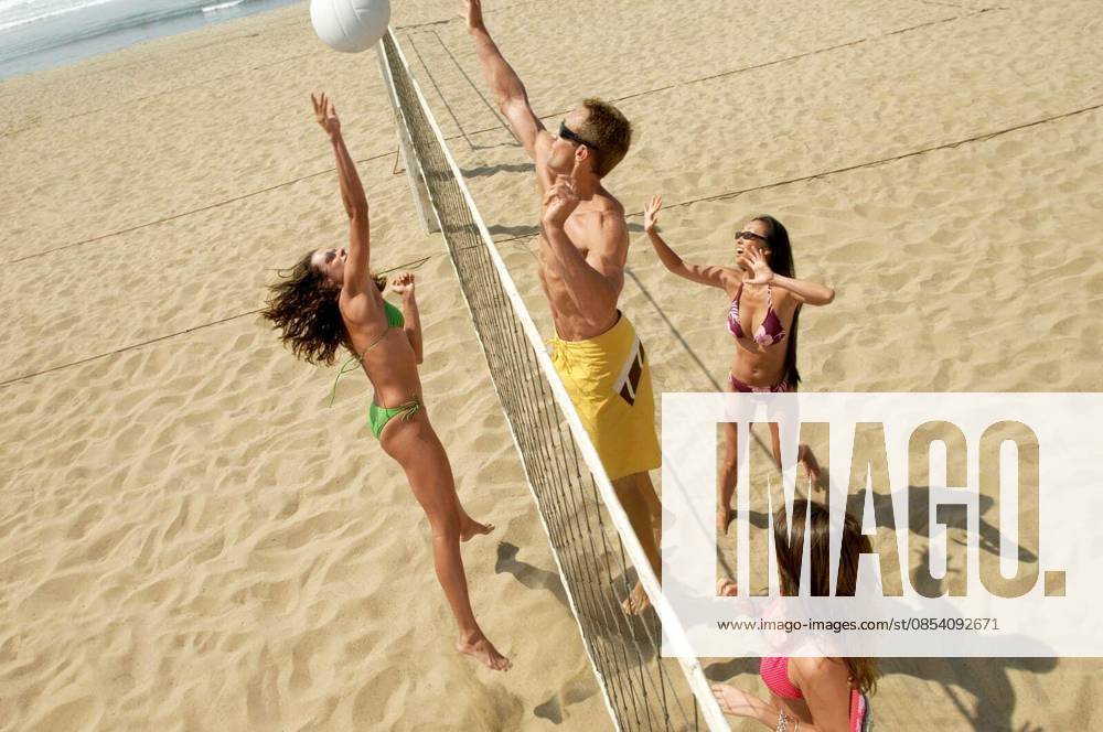 Multiethnic Friends Playing Volleyball On Beach - High angle view of happy multiethnic friends playing volleyball on beach model released Symbolfoto