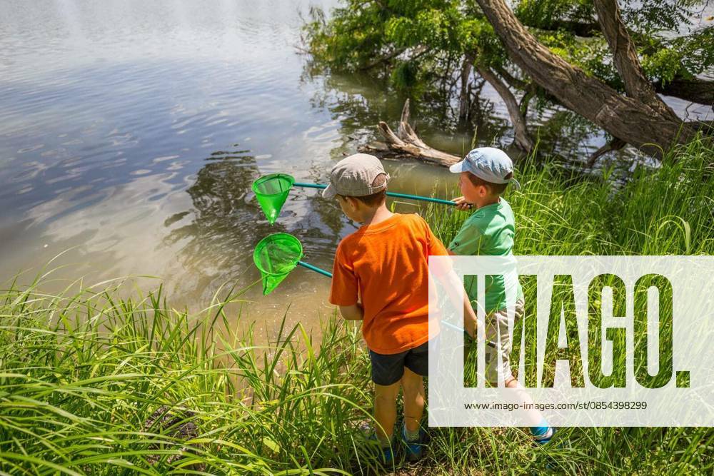 Two boys having fun with fishing nets model released Symbolfoto