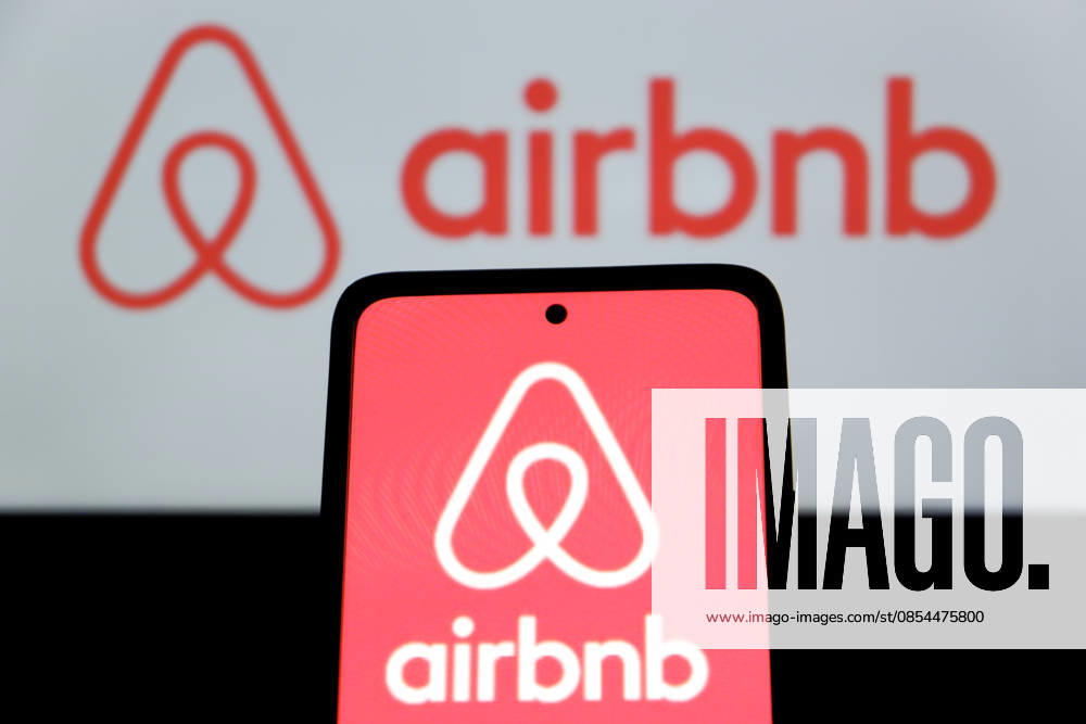 In this photo illustration, Airbnb logo is displayed on a smartphone with Airbnb logo in the background Bandung Indonesia - ZUMAs281 20260423_zip_s281_006