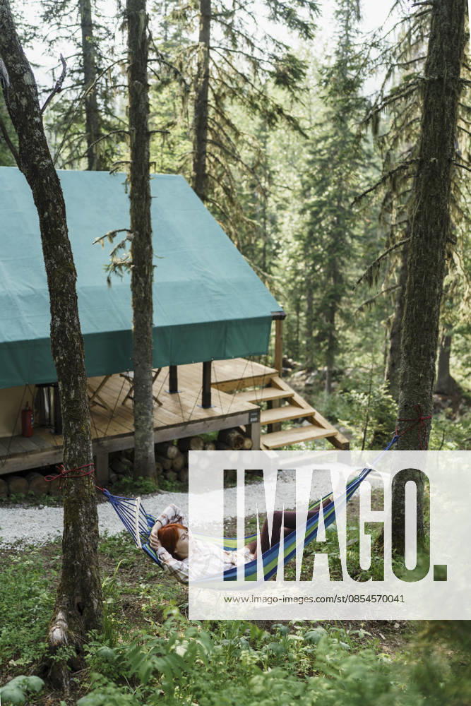 Serene camper resting in a hammock near Siberia glamping tent model released, Symbolfoto property released, VBUF00783