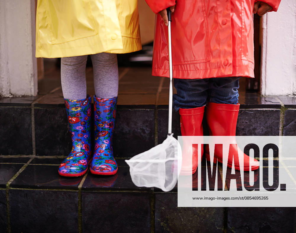 Ready for the rain. two children dressed in raincoats and galoshes (License=RF) ,model released, Symbolfoto