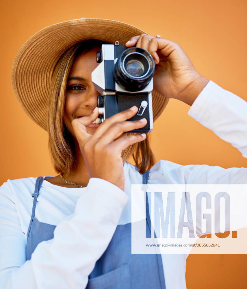 Camera, portrait and photographer woman isolated on wall background for summer beauty, holiday travel and fashion. Gen z, black person or model face with retro photography for vacation digital memory. (License=RF) ,model released, Symbolfoto