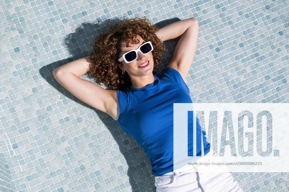 Model relaxing in an empty swimming pool in Granada during summer model released, Symbolfoto property released, LMCF02858
