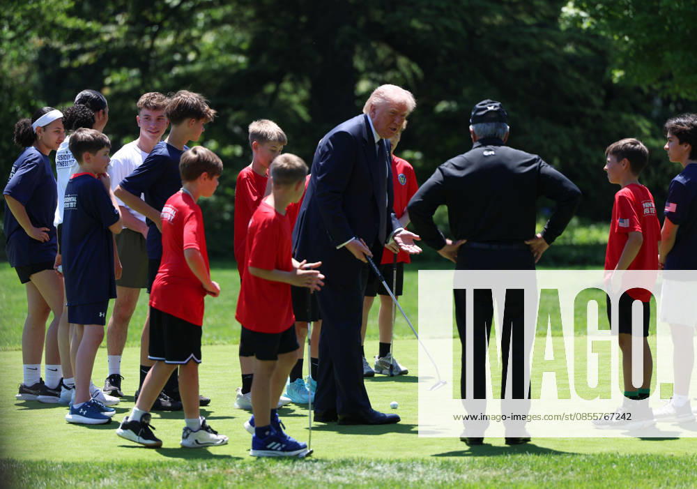 President Donald Trump gathers with children on the putting green on the South Lawn of the White House after he signed a proclamation inside the Oval Office at The White House in Washington, on May 5, 2026. The memorandum is set to restore the Presidential Fitness Test Award, a competitive school-based fitness program last seen under the Obama administration. WASP20260505103 TomxBrenner