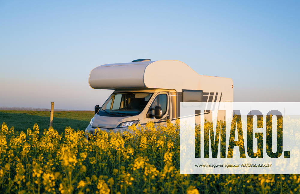 Campervan parked in blooming rapeseed field at golden hour countryside Mont Saint-Michel, Normandy, France CR_PJJZ260505A-2011208-01