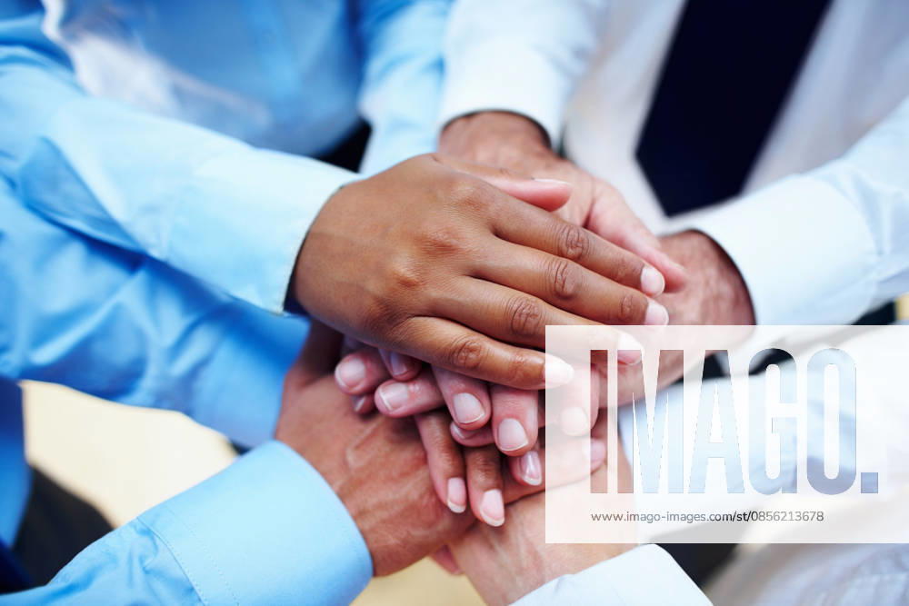 Business people, hands together and teamwork for motivation, unity or collaboration at office. Group of employees piling for building, diversity or meeting in trust, community or support at workplace. (License=RF) ,model released, Symbolfoto