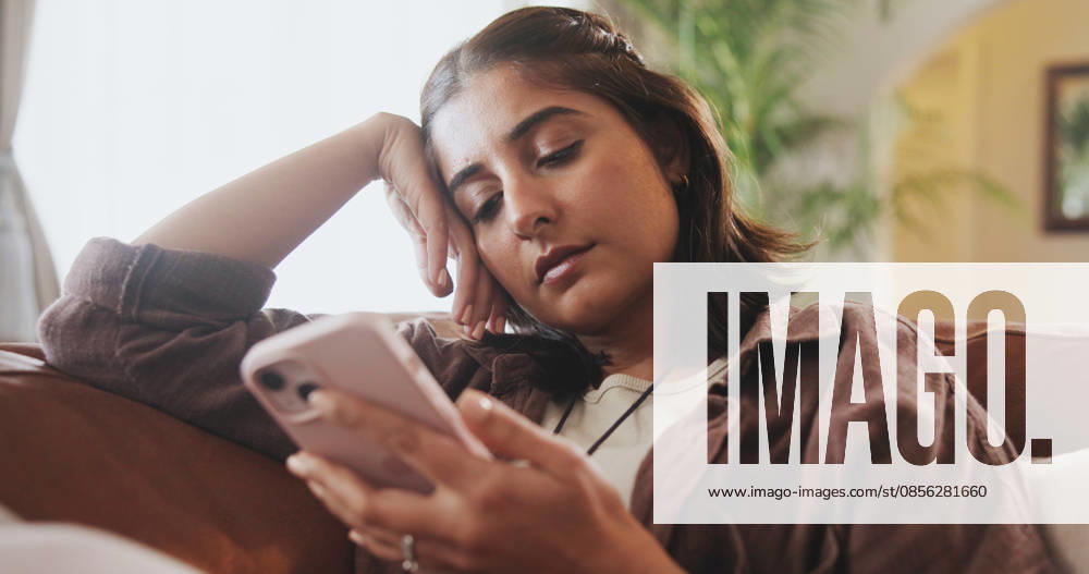 Home, relax and woman on couch, smartphone and typing with connection, social media or doom scrolling. Person, apartment or girl on sofa, cellphone or addiction with bad habit, network or digital app. (License=RF) ,model released, Symbolfoto