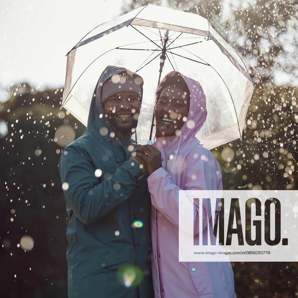 Portrait, smile and black couple with umbrella outdoor for laugh or bonding together in winter by water drop. Raincoat, happy man and woman in nature for love, protection or holding hands for support. (License=RF) ,model released, Symbolfoto
