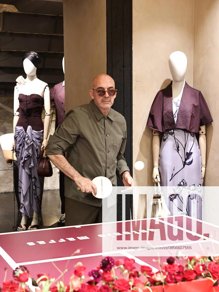 IPA84680212 - Rome, Laila Hasanovic attends the Antonio Marras boutique event. Pictured: Antonio Marras plays ping pong.