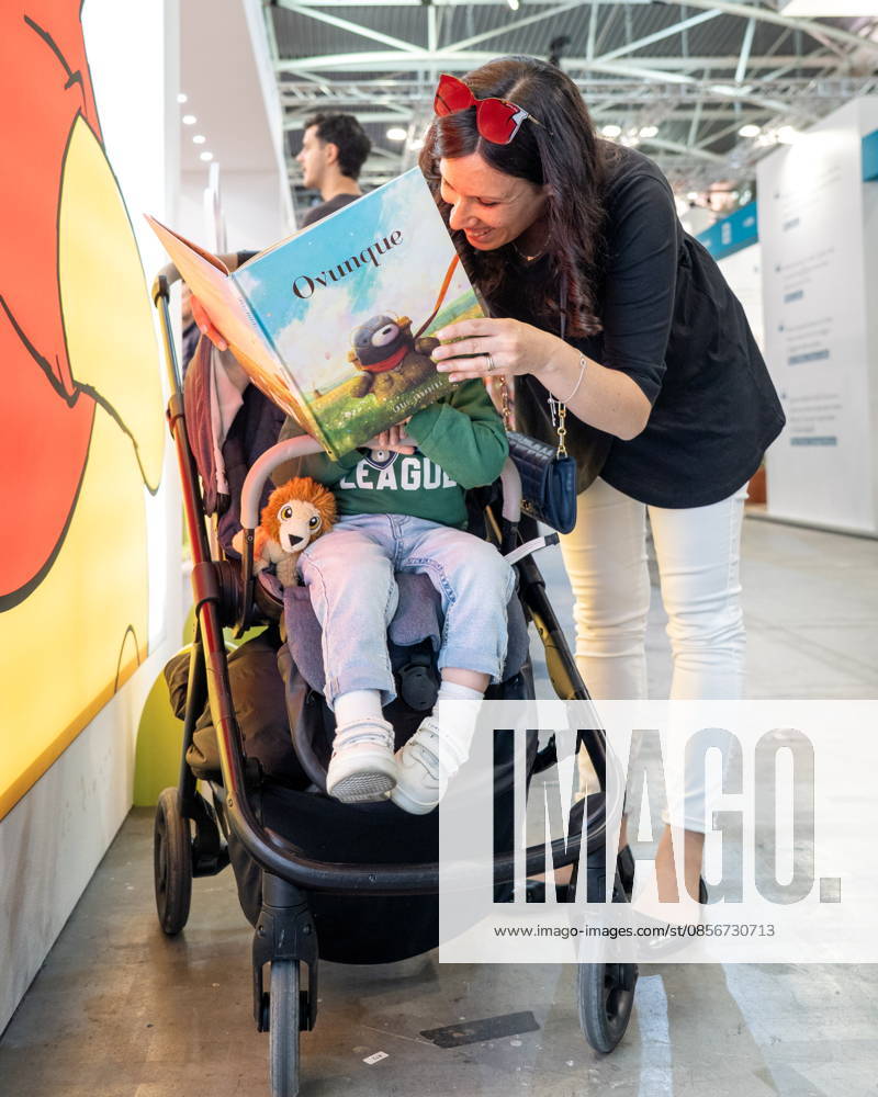Some moments from the second day of the International Book Fair. Pictured is a mother reading a book to a little girl. Turin, May 15, 2026 Turin Italy - ZUMAa289 20260515_zia_a289_015