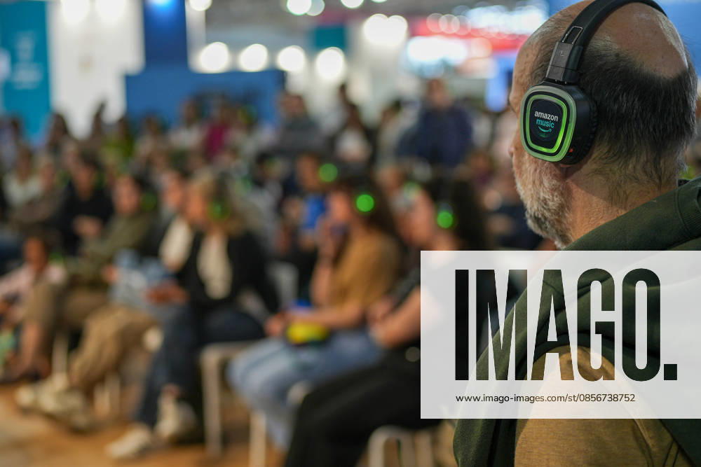 IPA84723876 - Turin. Second day of the 18th edition of the Turin International Book Fair entitled The World Saved by Kids. The fair will remain open from May 14 to 18, 2026 at Lingotto Fiere Pictured: audience listens to audiobooks