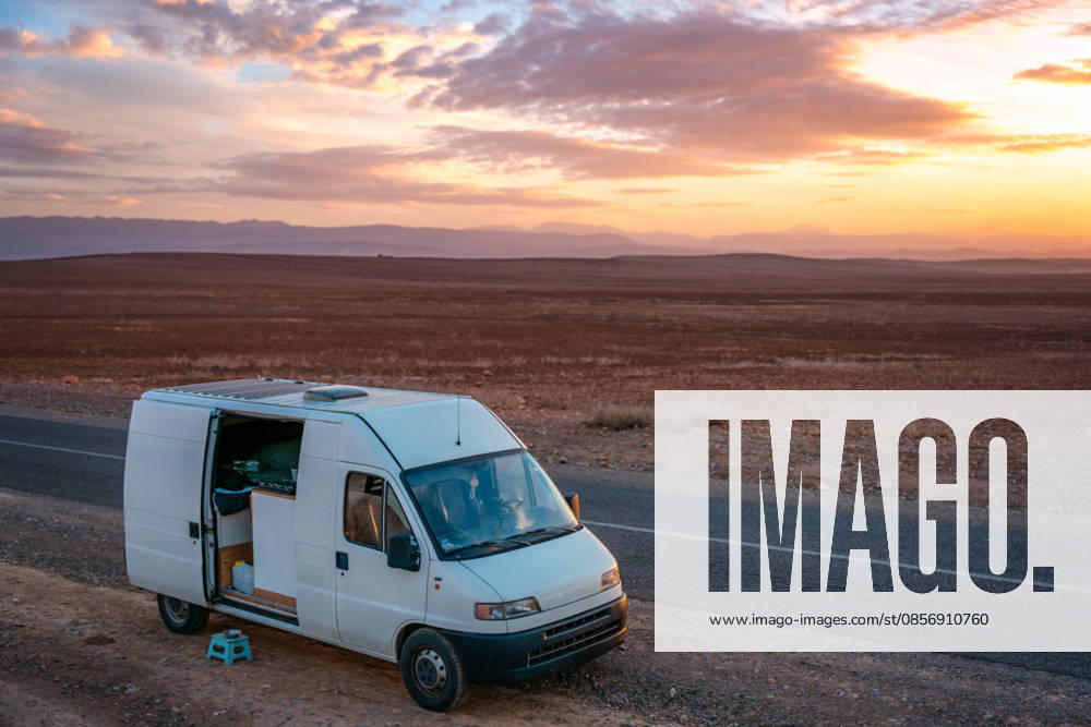 Camper van parked on a desert roadside at sunset in Morocco Ouzoud, Azilal Province, Morocco CR_UGOUSD260516-2024620-01