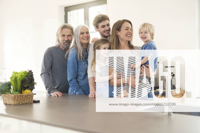 Happy family with grandparents and children standing in the kitchen model released Symbolfoto property released SBOF00517