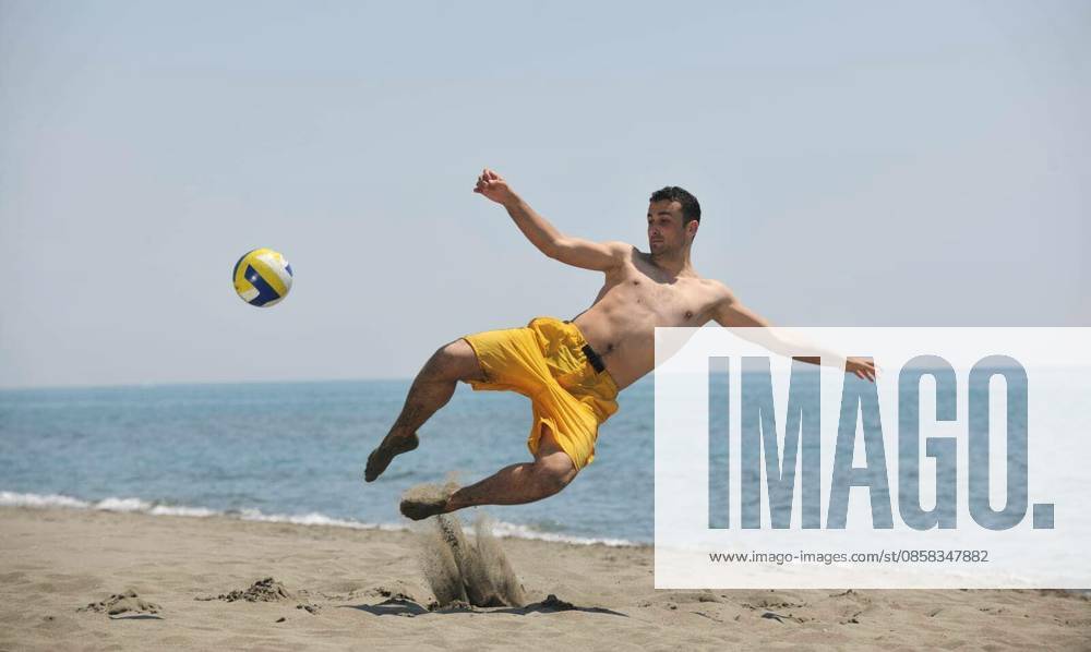Male beach volleyball game player jump on hot sand model released Symbolfoto