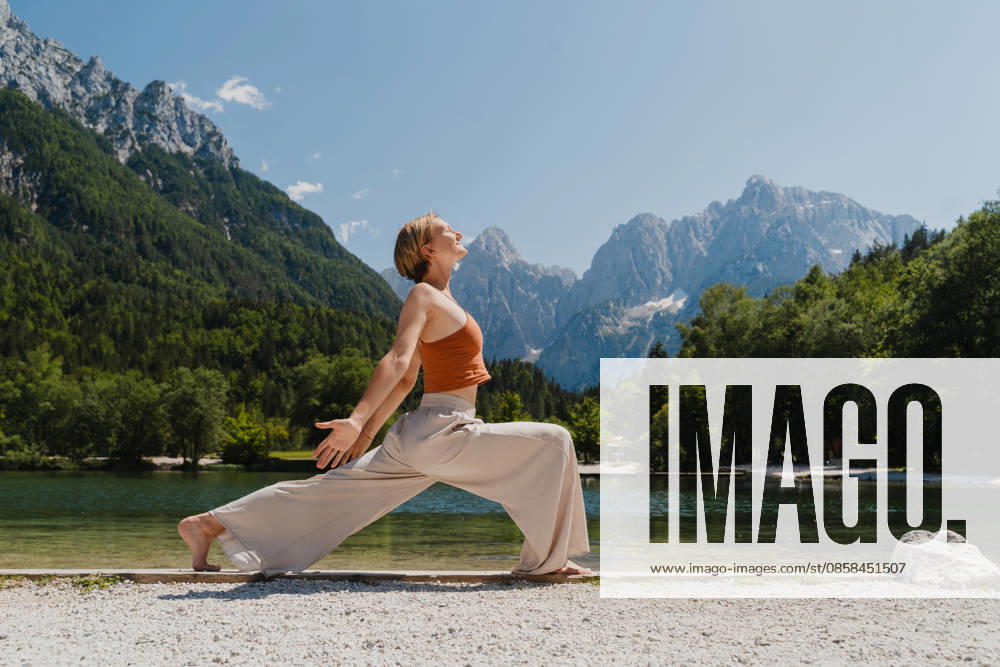 Woman practicing yoga by a mountain lake for mindfulness and relaxation model released, Symbolfoto, NDEF03293