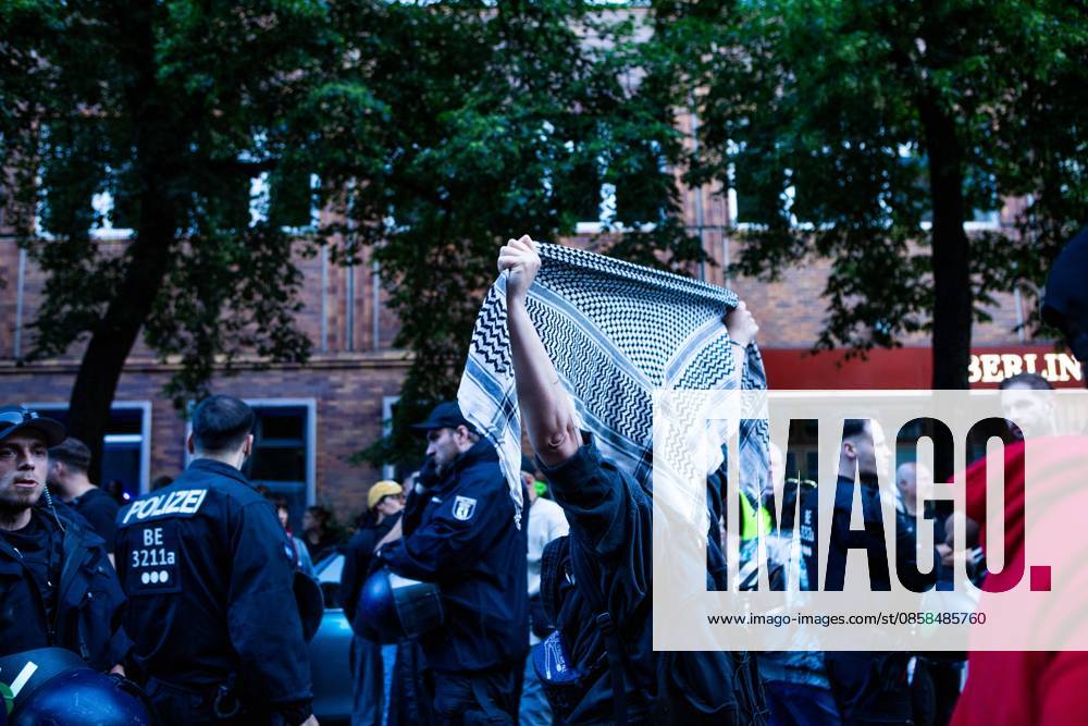 A demonstrator raises a Palestinian keffiyeh in protest in front of Berlin police officers during the Naksa Day demonstration that took place in Berlin. Berlin Germany - ZUMAc291 20260605_zip_c291_001