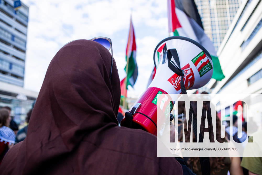 A protester carrying a megaphone stands among demonstrators and Palestinian flags during a Naksa Day event in Berlin. Berlin Germany - ZUMAc291 20260605_zip_c291_005