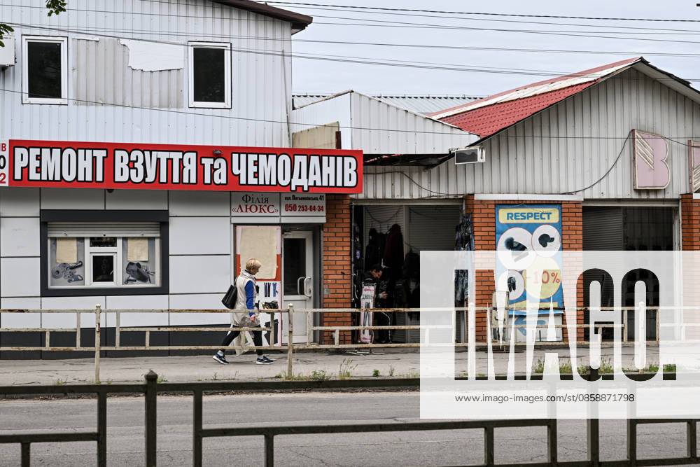 A woman walks past a clothing store in the red zone of the frontline city of Kherson, the area considered the most dangerous due to constant Russian attacks, Kherson, Ukraine, on June 3, 2026. The Russian army attacks the city daily with FPV drones and other unmanned aerial vehicles, deliberately terrorizing civilians. Russian forces conduct hunts for local residents, tracking them with FPV drones and dropping explosives. Police officers, medics, public transport, and urban infrastructure are also targeted. Based on the intensity of attacks, Kherson is informally divided into yellow and red zones, with the red zone subjected to continuous shelling and drone strikes (Photo by Dmytro Smolienko Ukrinform) Life under shelling in front