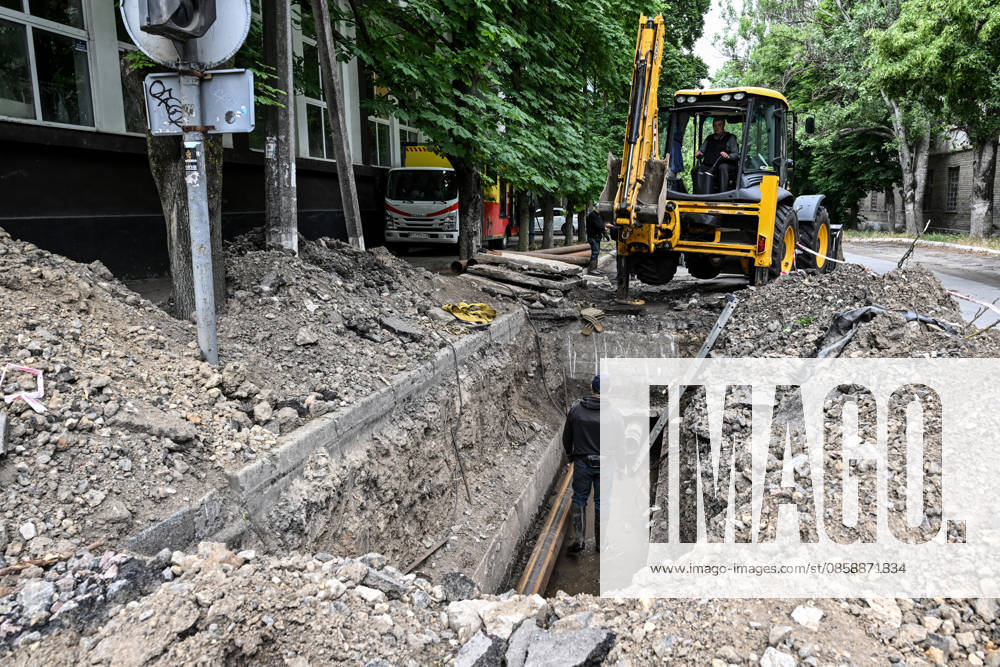 Municipal workers repair utility pipelines in the red zone of the frontline city of Kherson, the area considered the most dangerous due to constant Russian attacks, Kherson, Ukraine, on June 3, 2026. The Russian army attacks the city daily with FPV drones and other unmanned aerial vehicles, deliberately terrorizing civilians. Russian forces conduct hunts for local residents, tracking them with FPV drones and dropping explosives. Police officers, medics, public transport, and urban infrastructure are also targeted. Based on the intensity of attacks, Kherson is informally divided into yellow and red zones, with the red zone subjected to continuous shelling and drone strikes. Anti-drone netting has been installed above roads to help