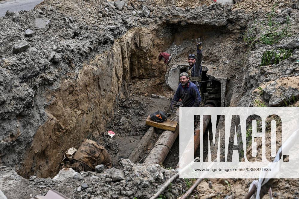 Municipal workers repair utility pipelines in the red zone of the frontline city of Kherson, the area considered the most dangerous due to constant Russian attacks, Kherson, Ukraine, on June 3, 2026. The Russian army attacks the city daily with FPV drones and other unmanned aerial vehicles, deliberately terrorizing civilians. Russian forces conduct hunts for local residents, tracking them with FPV drones and dropping explosives. Police officers, medics, public transport, and urban infrastructure are also targeted. Based on the intensity of attacks, Kherson is informally divided into yellow and red zones, with the red zone subjected to continuous shelling and drone strikes. Anti-drone netting has been installed above roads to help