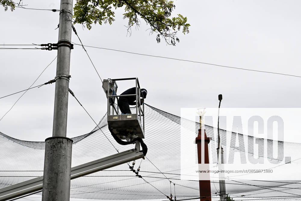 A municipal worker installs anti-drone netting to protect against Russian FPV drones in the yellow zone of the frontline city of Kherson, Ukraine, on June 3, 2026. The Russian army attacks the city daily with FPV drones and other unmanned aerial vehicles, deliberately terrorizing civilians. Russian forces conduct hunts for local residents, tracking them with FPV drones and dropping explosives. Police officers, medics, public transport, and urban infrastructure are also targeted. Based on the intensity of attacks, Kherson is informally divided into yellow and red zones, with the red zone being the most dangerous due to constant shelling and drone strikes (Photo by Dmytro Smolienko Ukrinform) Life under shelling in frontline Kherson