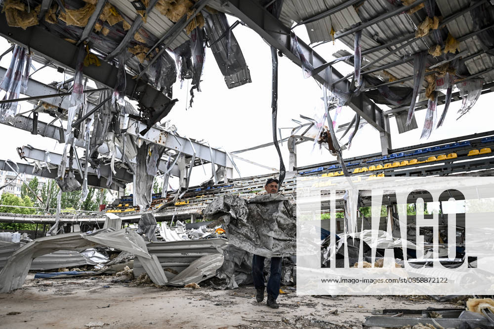 A worker carries a sheet of corrugated metal while clearing debris at the site of the Favoryt Arena ice sports palace, destroyed in Russian guided aerial bomb (KAB) strikes, in the frontline city of Kherson, Ukraine, on June 3, 2026. The Russian army attacks the city daily with FPV drones and other unmanned aerial vehicles, deliberately terrorizing civilians. Russian forces conduct hunts for local residents, tracking them with FPV drones and dropping explosives. Police officers, medics, public transport, and urban infrastructure are also targeted (Photo by Dmytro Smolienko Ukrinform) Life under shelling in frontline Kherson