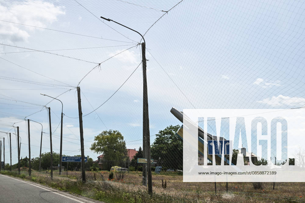 The MiG-19 memorial commemorating the 40th anniversary of Victory stands at the entrance to Kherson International Airport in Chornobaivka, Kherson region, Ukraine, on June 2, 2026. The road leading to the airport is protected by anti-drone netting. The Russian army attacks Kherson and the surrounding region daily with FPV drones and other unmanned aerial vehicles, deliberately terrorizing civilians. Russian forces track residents using FPV drones and _drop_ explosives on them. Police officers, medics, public transport, and civilian infrastructure are also frequently targeted (Photo by Dmytro Smolienko Ukrinform) Life under shelling in frontline Kherson