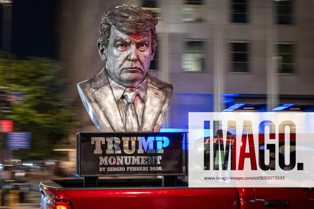 A truck carrying a statue depicting President Donald Trump drives near the White House in Washington, D.C., ahead of UFC Freedom 250 and events marking the President s 80th birthday. Lexington U.S. - ZUMAk206 20260613_znp_k206_004
