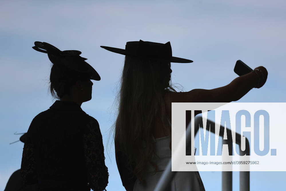 Ascot, Windsor, GBR - Fashion, women with hats at the racecourse silhouetted against the sky. Ascot racecourse. (Zuschauer, Besucher, Publikum, Frauen, Huete, Kopfbedeckungen, Fashion, Eleganz, elegant, Mode, modisch, feminin, Rueckansicht, Silhouette, Schattenriss, Umriss, Gegenlicht, Gegenlichtaufnahme) 260616D503ROYAL_ASCOT