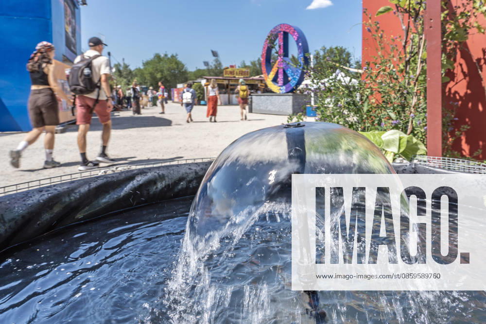 Eröffnung des Tollwood Sommerfestivals 2026, Besucher können sich bei hochsommerlichen Temperaturen über 30 Grad an diesen Brunnen abkühlen, München, 19. Juni 2026 Deutschland, München, 19. Juni 2026, Eröffnung des Tollwood Sommerfestivals 2026, einer von mehreren kleinen Kühlbrunnen, an denen sich die Besucher abkühlen können, Teil des neuen Tollwood-Hitzekonzepts, Besucher schwitzen bei Rekordtemperaturen über 30 Grad, Hochsommer, das Tollwood ist ein multikulturelles Festival, das im Sommer im Olympiapark stattfindet, dieses Jahr vom 19. Juni bis 19. Juli, 2026 unter dem Motto: Mit Gefühl statt nur dabei die Rückeroberung der Empathie, Festivalgelände, Sommer, Kultur, Veranstaltung, Klima, Bayern