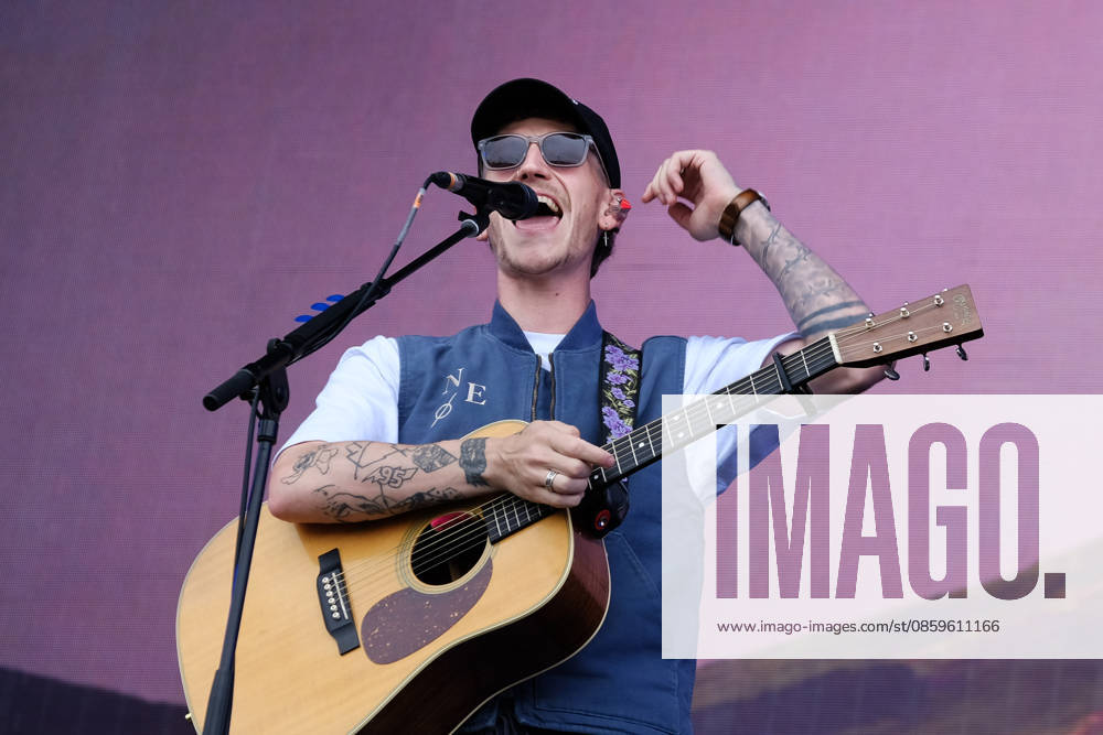 Scottish singer songwriter Nathan Evans born Nathan Alexander Evans, performing live on stage with The Saint PHNX Band at the Isle of Wight festival. He first gained fame in 2020 by posting videos of himself singing sea shanties on TikTok. In 2021, he released a version of the folk song Wellerman which peaked at the top of the UK Singles Chart. The Saint PHNX Band is currently Nathan Evans Lead vocals and acoustic guitar., Stevie Jukes Lead vocals, guitar, and bass, Alan Jukes Backing vocals, drums, and percussion Newport United Kingdom - ZUMAs197 20260620_aaa_s197_144