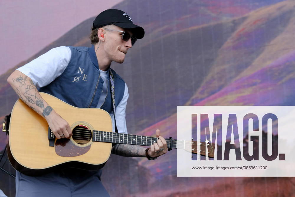 Scottish singer songwriter Nathan Evans born Nathan Alexander Evans, performing live on stage with The Saint PHNX Band at the Isle of Wight festival. He first gained fame in 2020 by posting videos of himself singing sea shanties on TikTok. In 2021, he released a version of the folk song Wellerman which peaked at the top of the UK Singles Chart. The Saint PHNX Band is currently Nathan Evans Lead vocals and acoustic guitar., Stevie Jukes Lead vocals, guitar, and bass, Alan Jukes Backing vocals, drums, and percussion Newport United Kingdom - ZUMAs197 20260620_aaa_s197_150