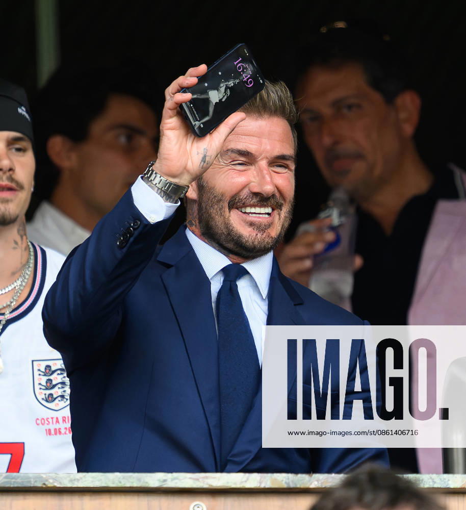 Norway v England - Miami Stadium- Quarter Final - 2026 World Cup - USA. 11 July 2026 - Norway v England - Miami Stadium- Quarter Final - 2026 World Cup - USA. David Beckham watches from the stands before the game and holds up his mobile phone which shows that he has an image of his wife Victoria Beckham from her days as a member of the Spice Girls as his phone s wallpper screensaver. Picture : Mark Pain MIAMI USA