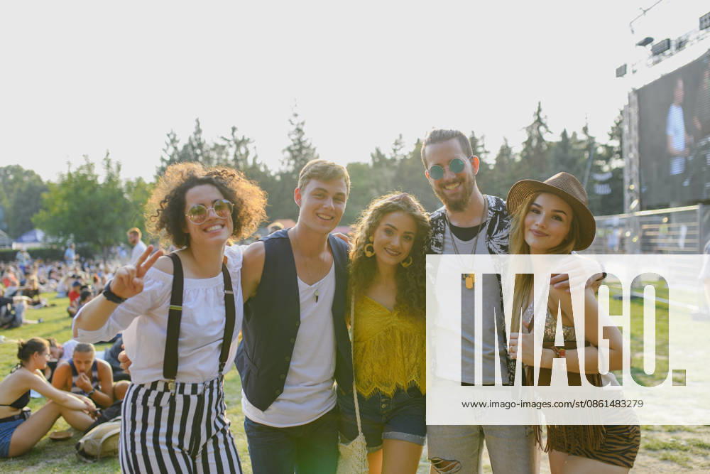 Group of young friends at summer festival. Group of cheerful young friends at summer festival, looking at camera. model released