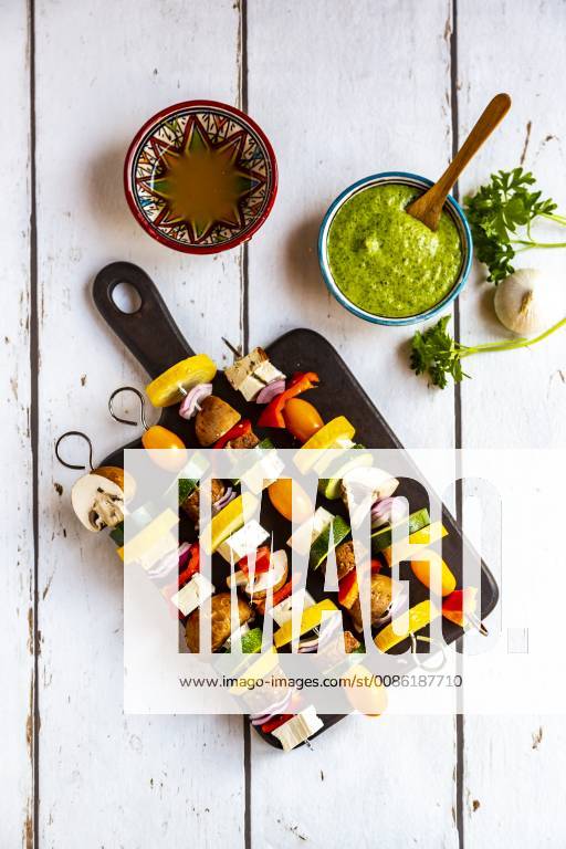 Vegetarian grill skewers, tomato, yellow and green zucchini, tofu, feta, onion and champignon, Argentinian chimichurri SARF03925