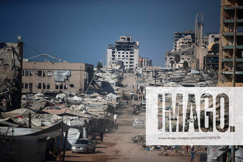 Aftermath of Israeli Airstrike In Gaza Palestinians walk among destroyed buildings in Gaza City, Gaza, on an unspecified date. Gaza remains subject to daily violence despite a formal ceasefire in place since October, with both the Israeli military and Hamas accusing one another of violating the truce. Gaza Palestine