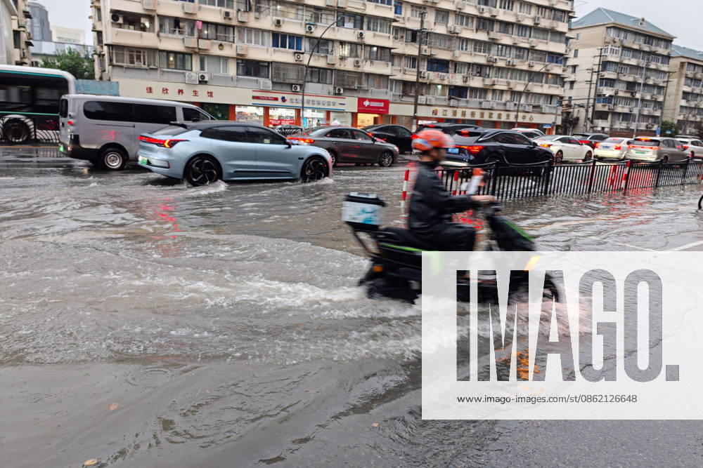 A motorcyclist drives through flooded street due to heavy rainstorms on July 19, 2026 in Shanghai, China. Shanghai Meteorological Observatory upgraded the rainstorm alert from yellow to orange for the central urban area at 14:35 on July 19.