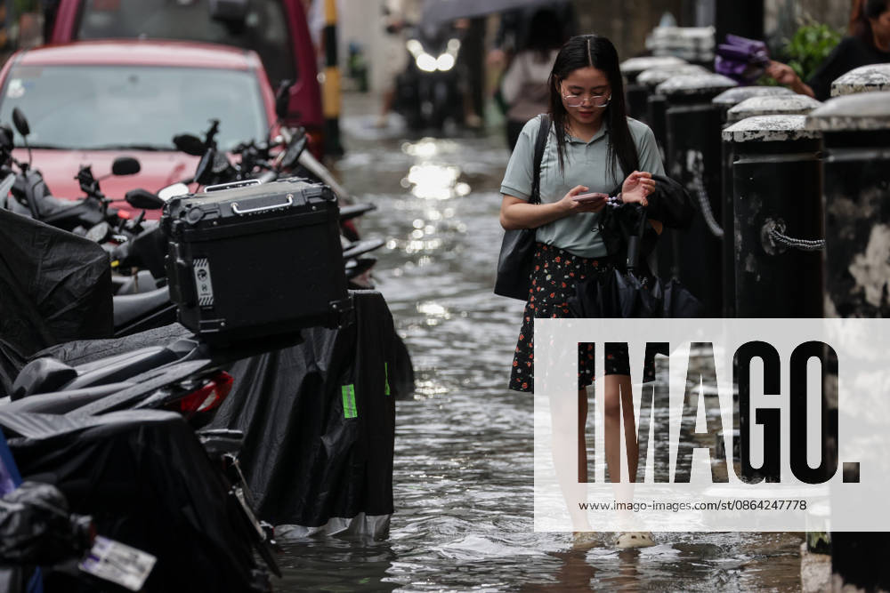 Heavy Rainfall To Continue In Manila A woman wades along a flooded road in Makati City, Manila, Philippines, on August 17, 2026. According to the Philippine Atmospheric, Geophysical, Astronomical and Services Administration s (PAGASA) latest weather forecast, the southwest monsoon will continue to bring heavy rainfall in Luzon, which includes Metro Manila, Ilocos Norte, Batanes, Cagayan, Cordillera Administrative Region, Tarlac, Pampanga, Cavite and Batangas. Makati Philippines